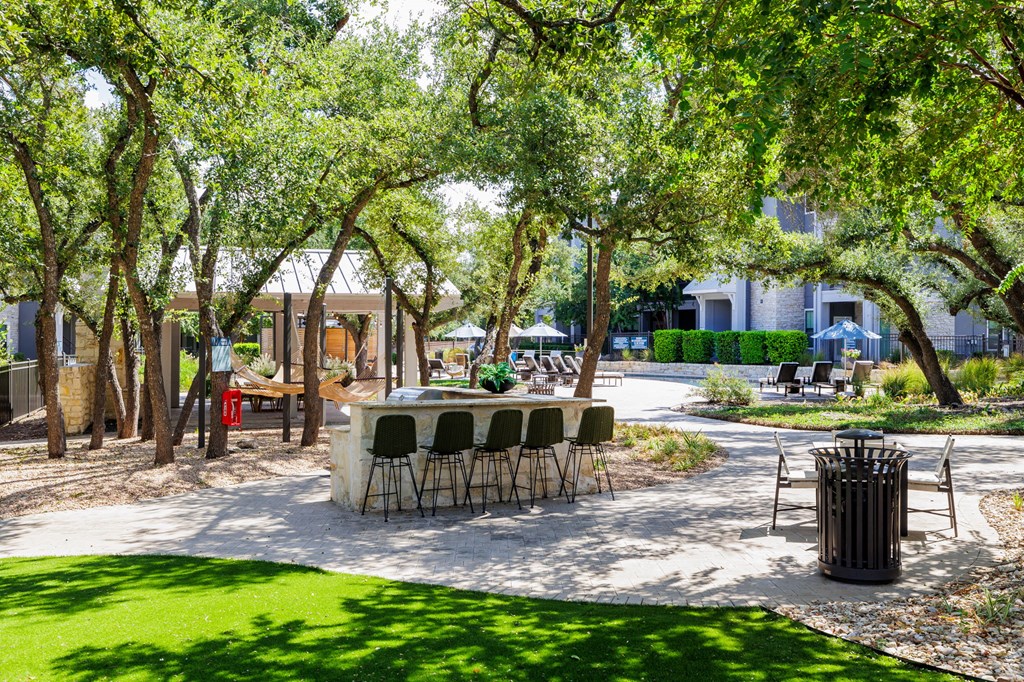 Green landscaping around the resident pool