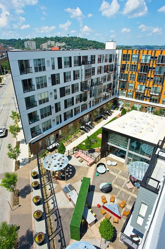 A modern building with a courtyard and a fire pit.