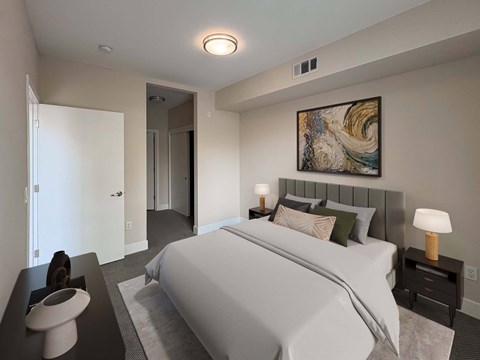 A bedroom with a large bed and a painting on the wall.
