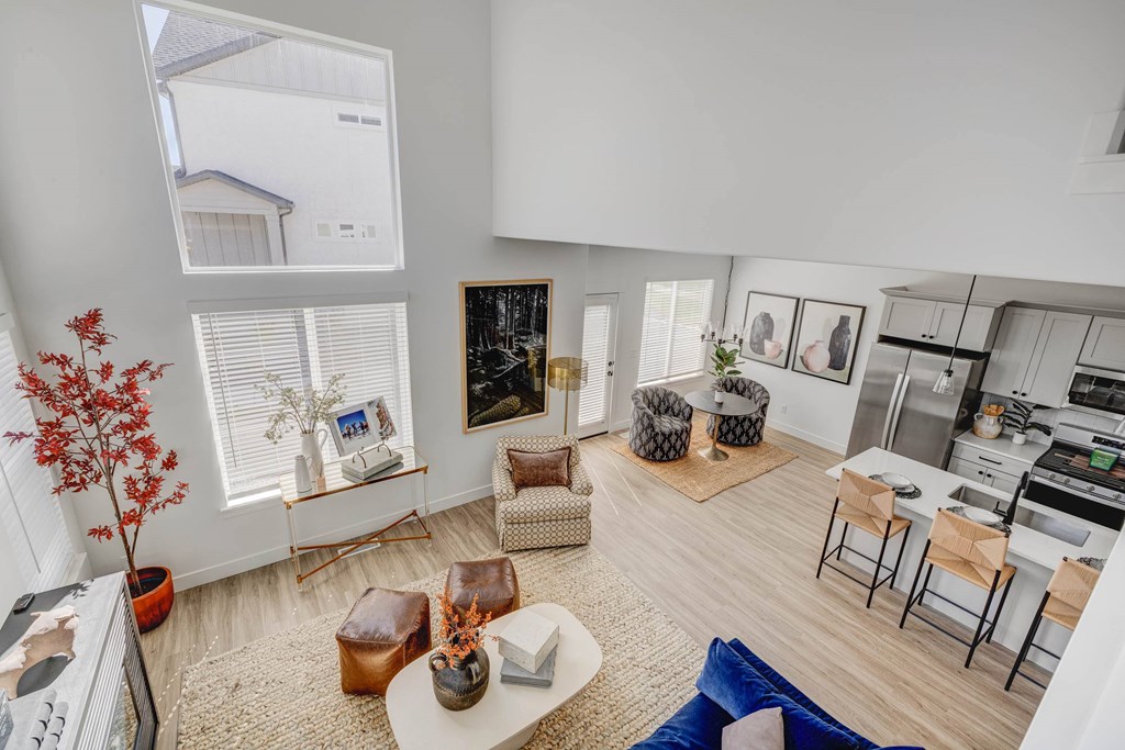 A modern living room with a white coffee table and a blue sofa.