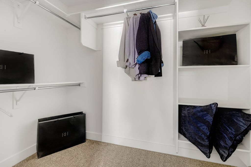 A room with a white wall and a black box on the floor.