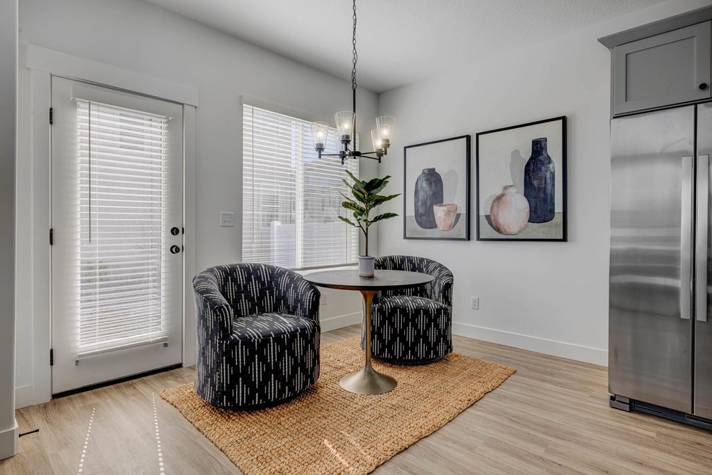 A living room with two chairs and a table.