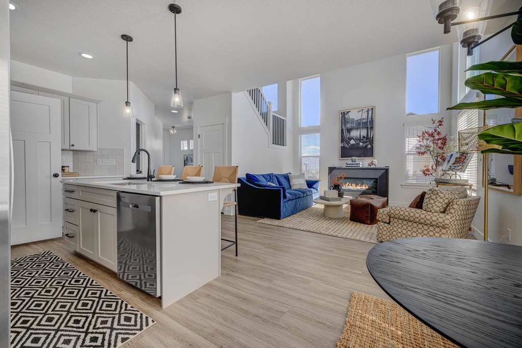 A modern kitchen with a dining table and chairs.