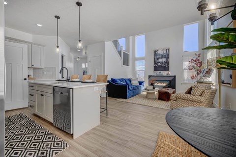 A modern kitchen with a dining table and chairs.