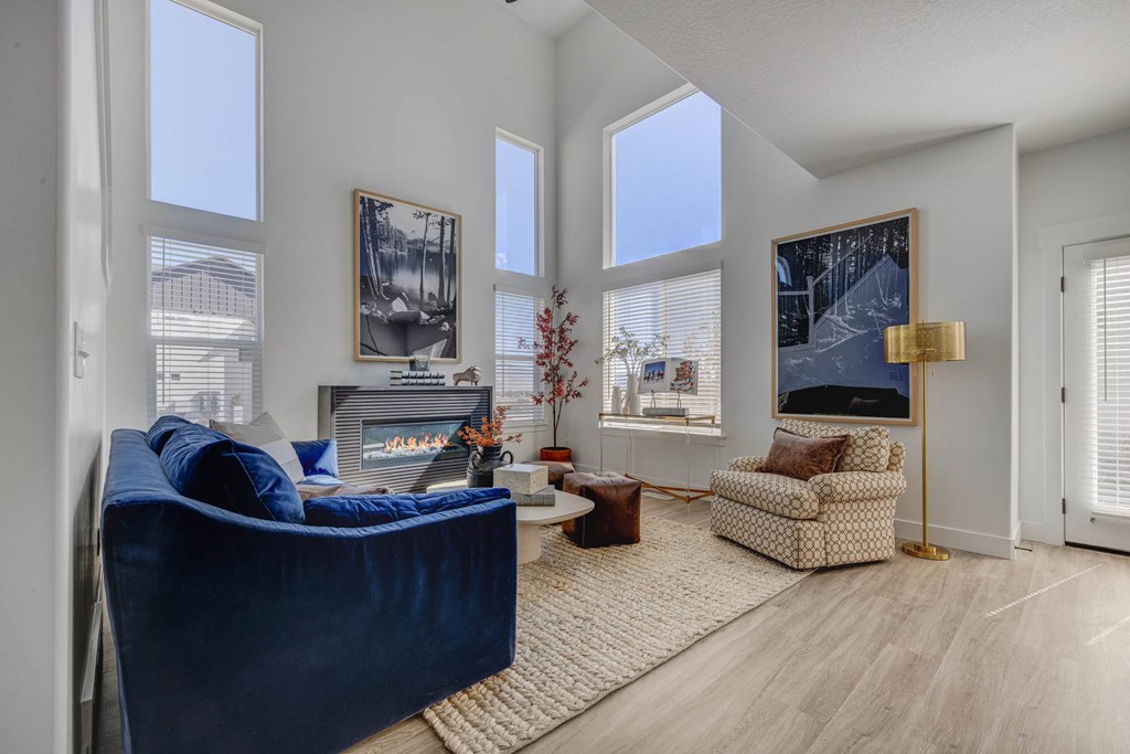 A living room with a blue couch, a chair, and a coffee table.
