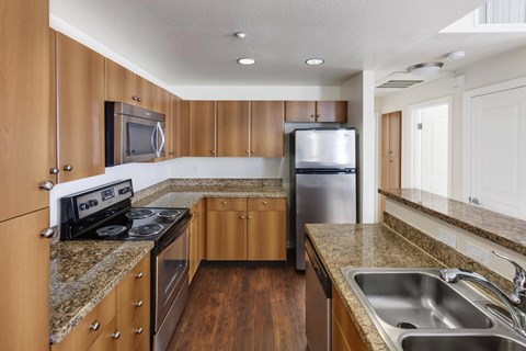 A kitchen with wooden cabinets and stainless steel appliances.