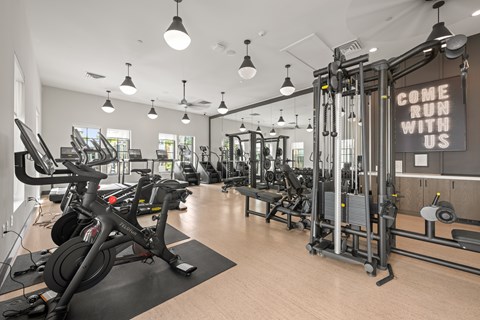 A gym with a sign that says "Come run with us" is shown.