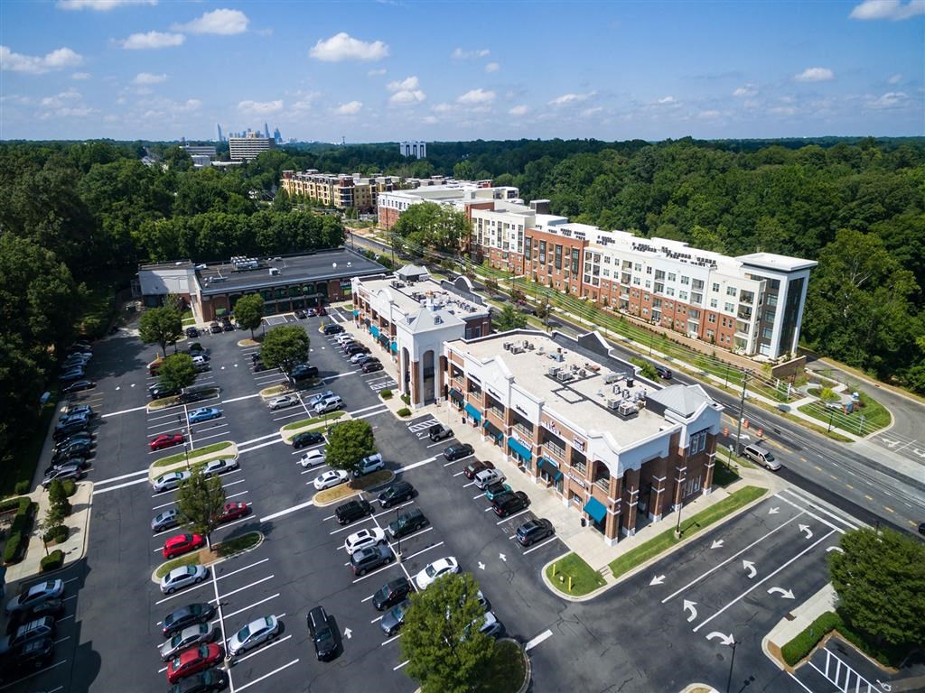 an aerial view of a parking lot and buildings