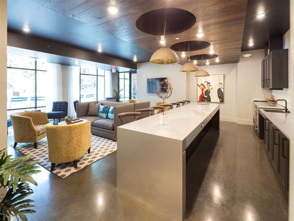 a large living room with a kitchen and a table