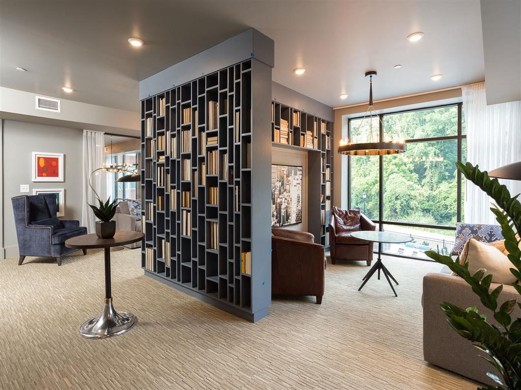 a living room filled with furniture and a large screen