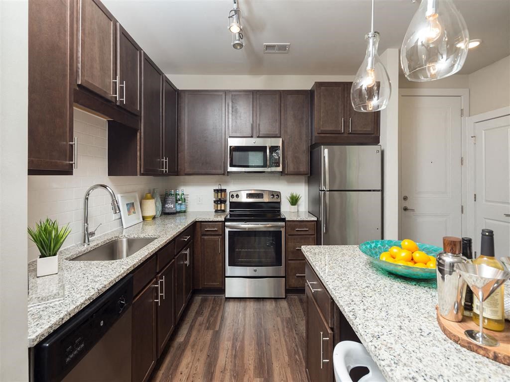 a kitchen with stainless steel appliances and granite counter tops