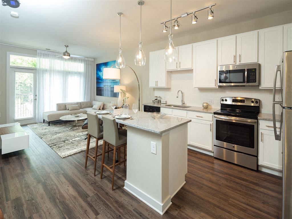 a kitchen and living room with an island in the middle