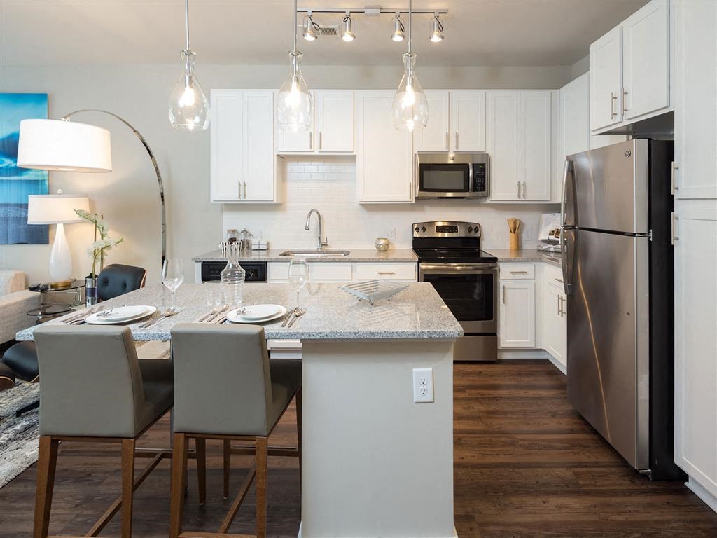 a kitchen and dining room with stainless steel appliances