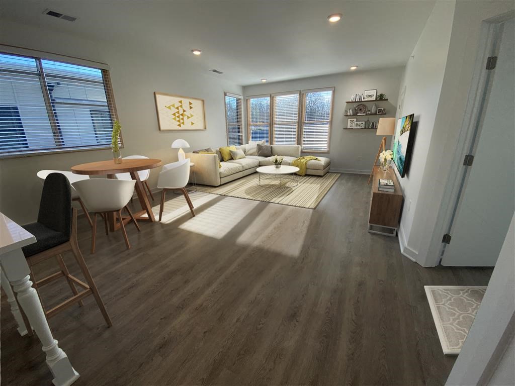 a living room filled with furniture and a large window