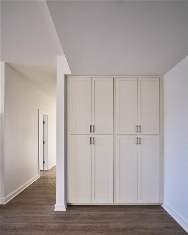 a white room with a white closet and a white door
