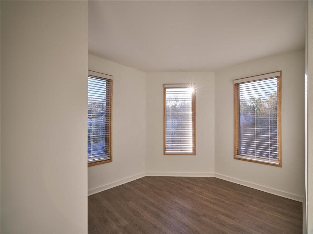 an empty room with three windows