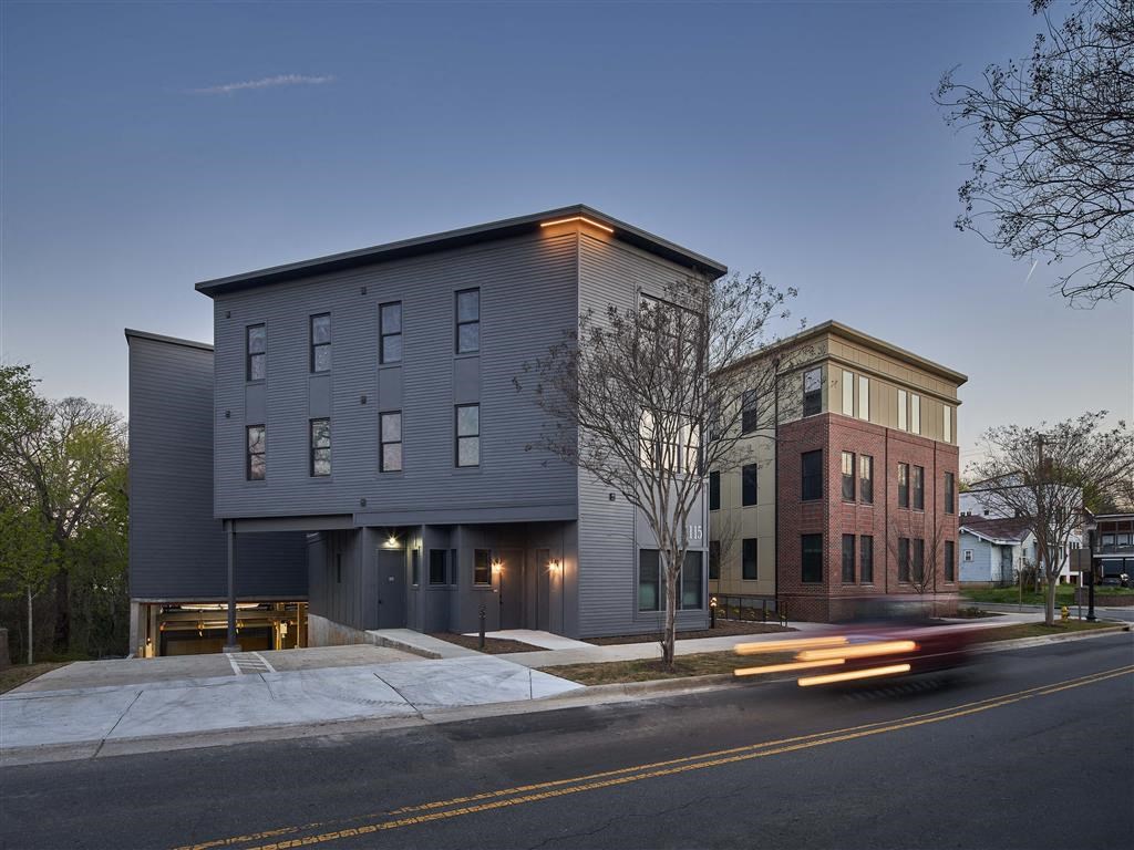 a view of the building from the street at dusk