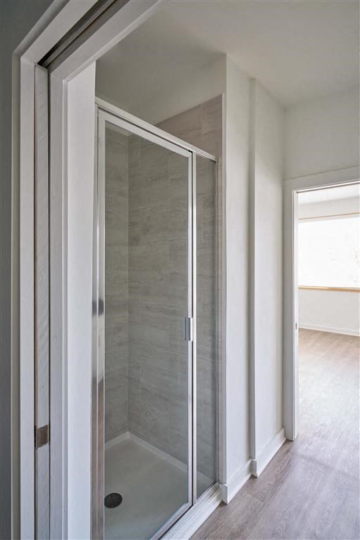 a bathroom with a walk in shower next to a door