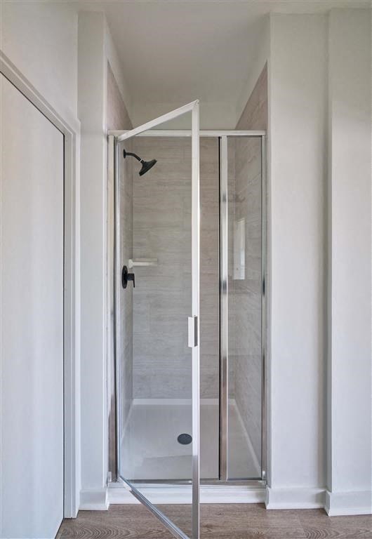 a walk in shower with a glass door in a bathroom