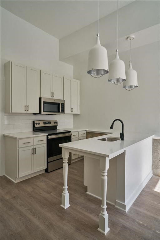 a kitchen with a white counter top and a stove top oven