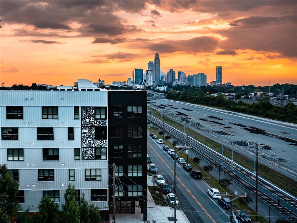 a view of the city skyline at sunset from a high rise building