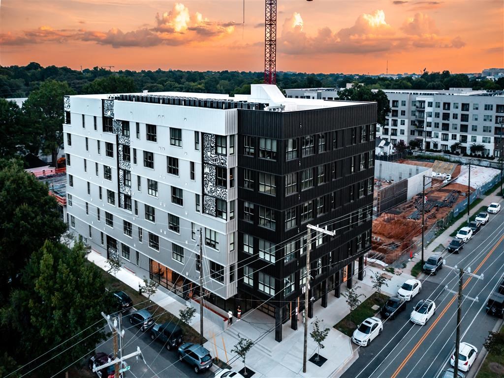 an aerial view of a tall building on a city street