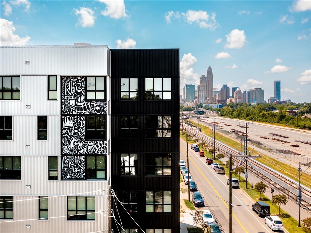 a black and white building with a city in the background