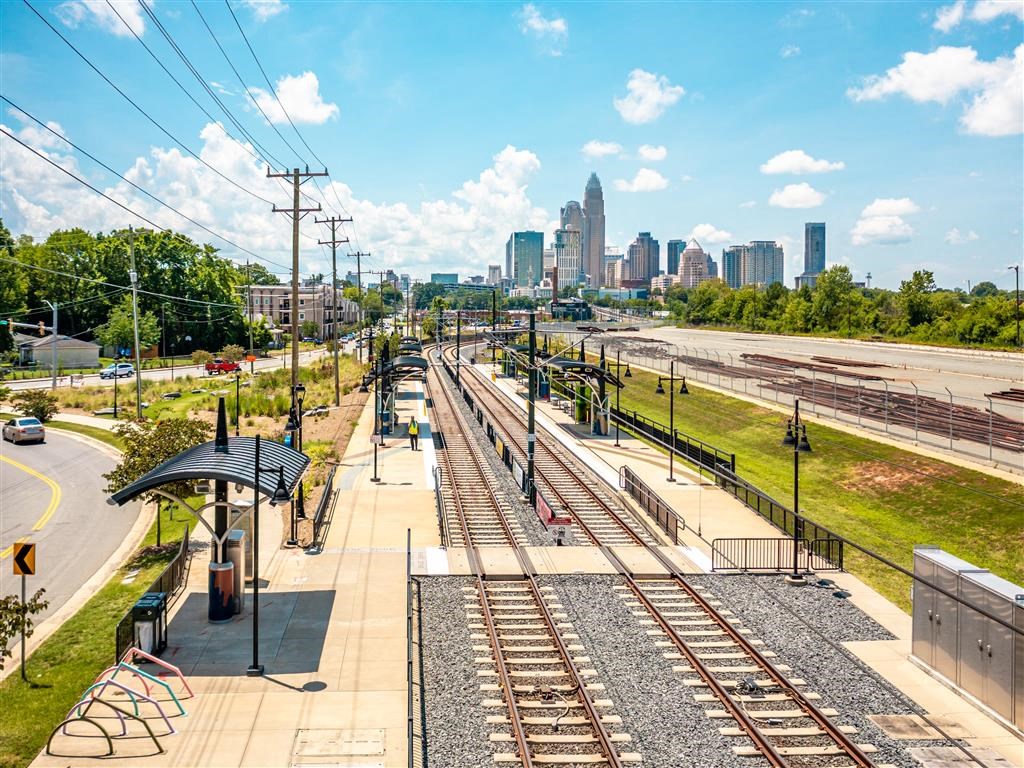 a train station with the city skyline in the background