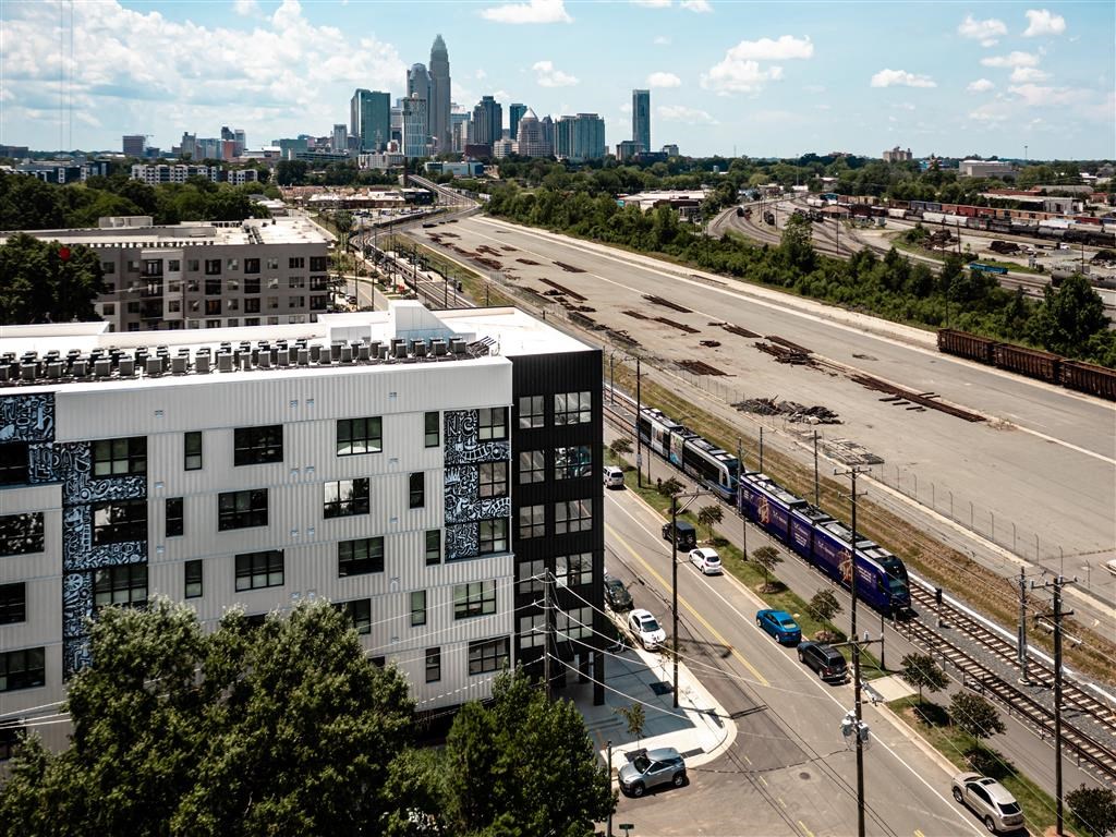an aerial view of a building with a city in the background