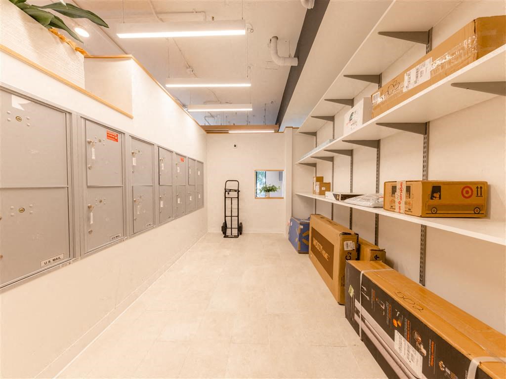 a long room with lockers and boxes on the shelves