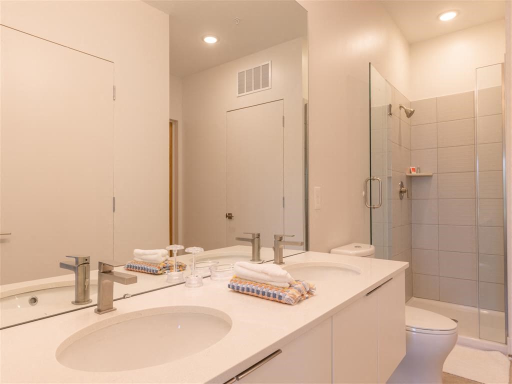 a bathroom with a sink and a toilet and a shower