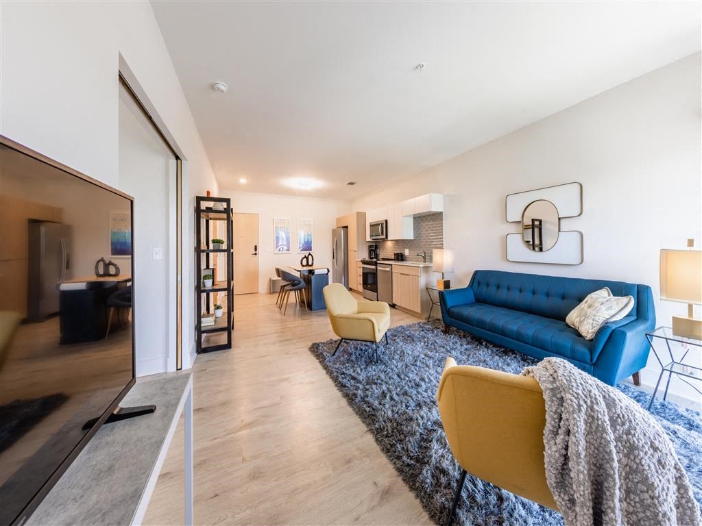 a living room with a blue couch and a rug