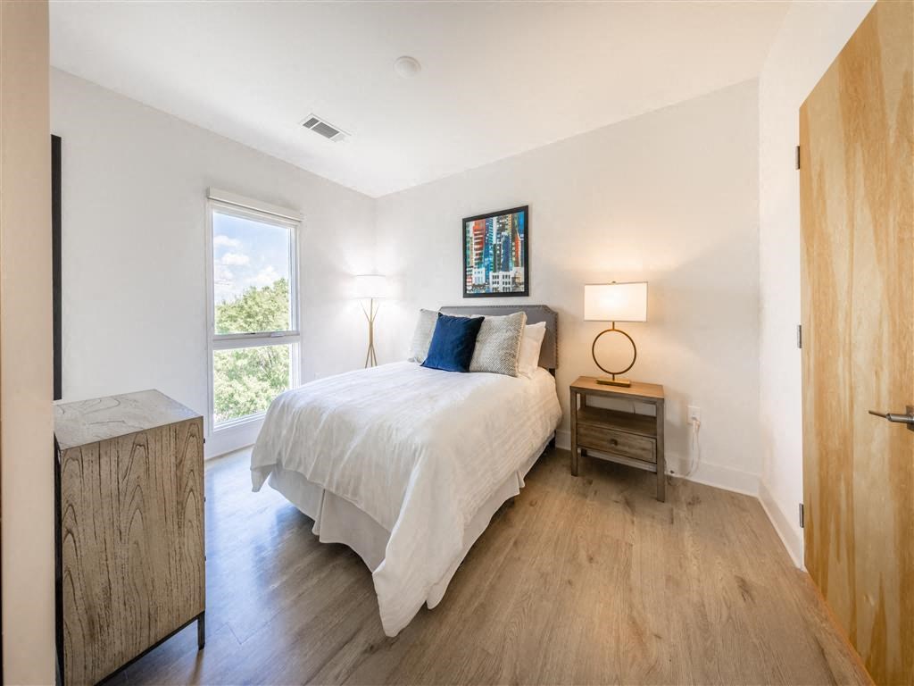 a bedroom with a bed and a window