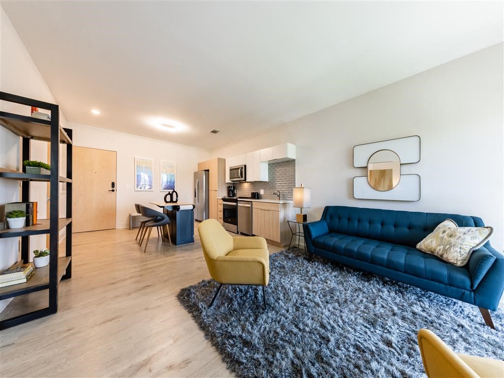 a living room with a blue couch and a rug