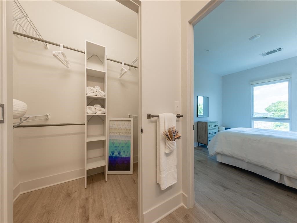 a bedroom with a closet and a bed and a mirror