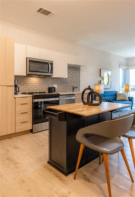 a kitchen with a table and chairs