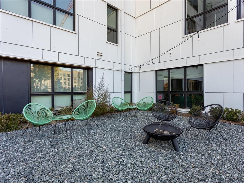 a group of chairs and a table outside of a building