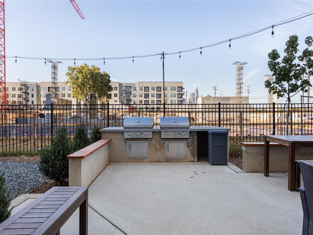 a patio with two gas bbqs and a picnic table