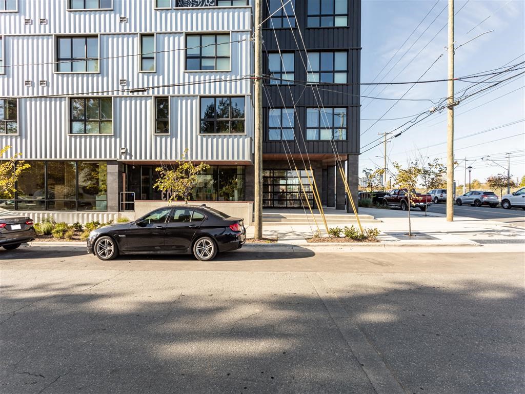 a black car parked in front of a building