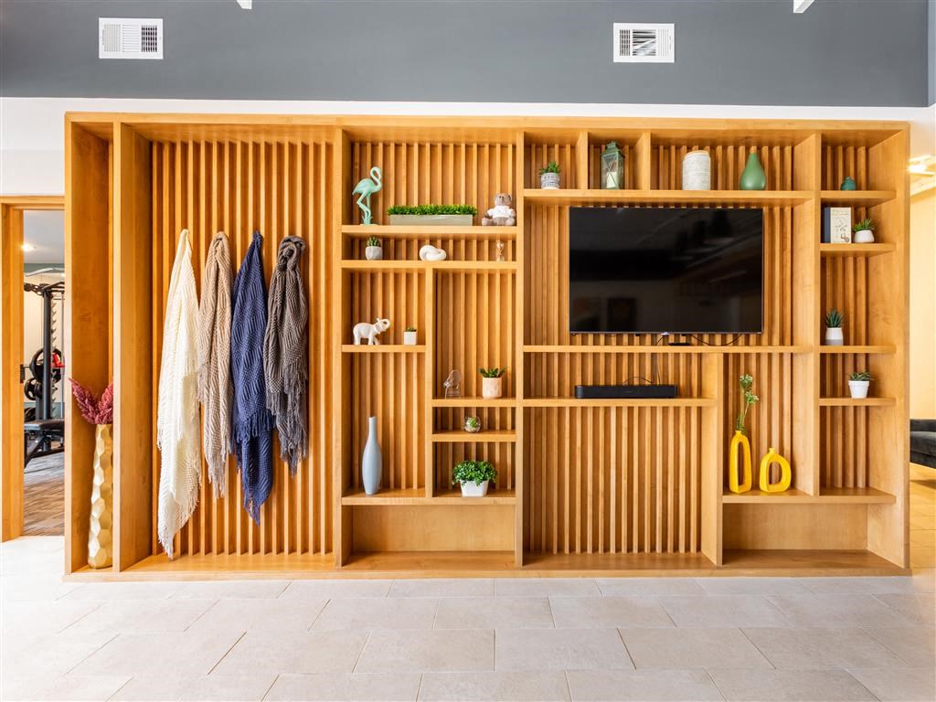a wooden wardrobe with a television in a living room