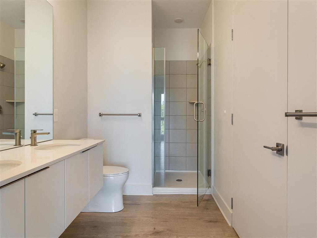 a bathroom with a toilet and a shower