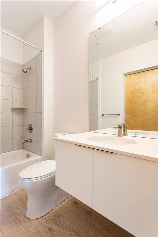 a white bathroom with a toilet and a sink
