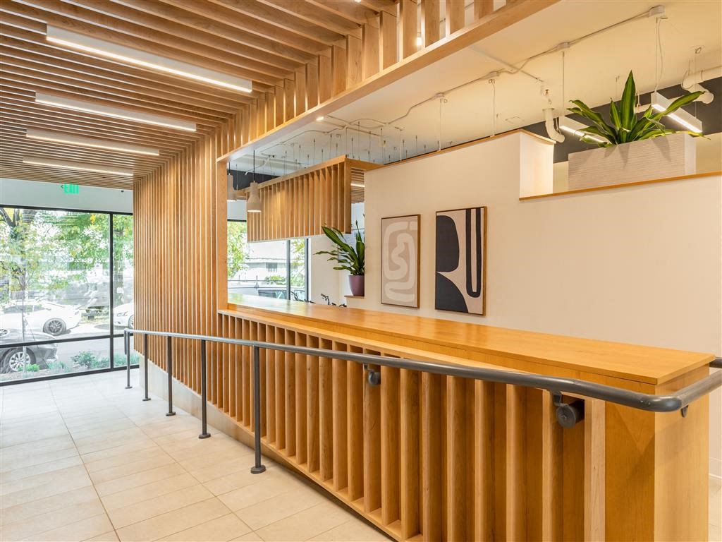 the lobby or reception area of a hotel with a wooden bar