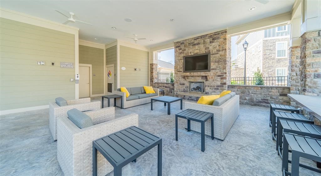 a living room with couches tables and a fireplace