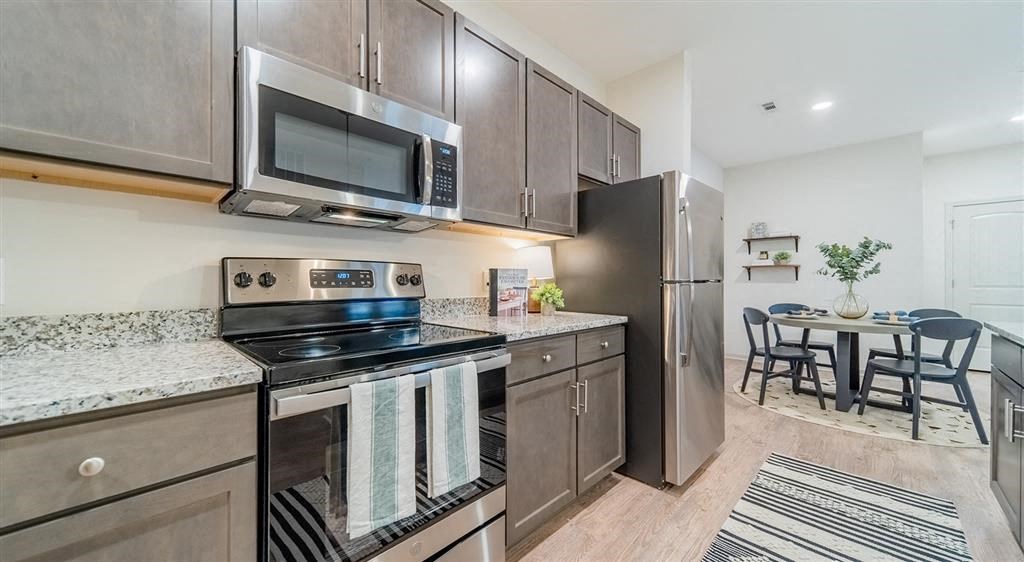 a kitchen with a stove top oven next to a refrigerator