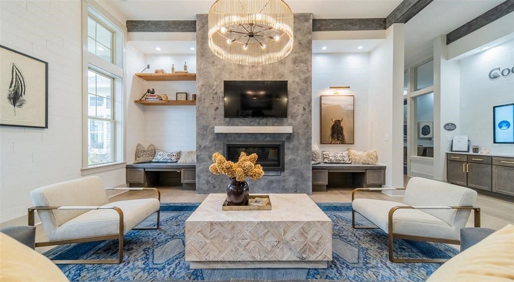 a living room with a fireplace and a large window