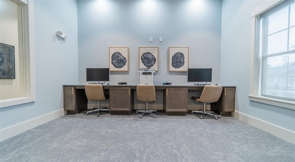 a large desk with three computer monitors on top of it