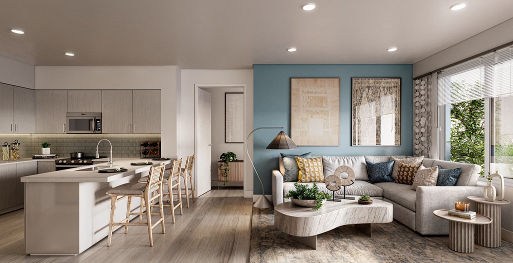 a living room and kitchen with a blue accent wall