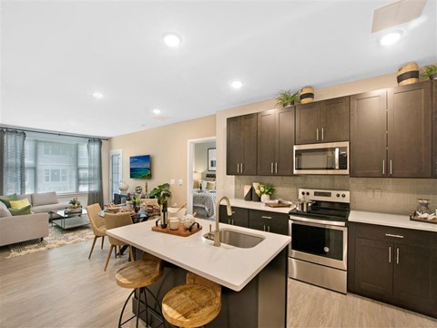 a kitchen and living room with a table