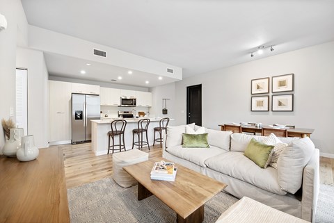 A modern living room with a white sofa and a wooden coffee table.